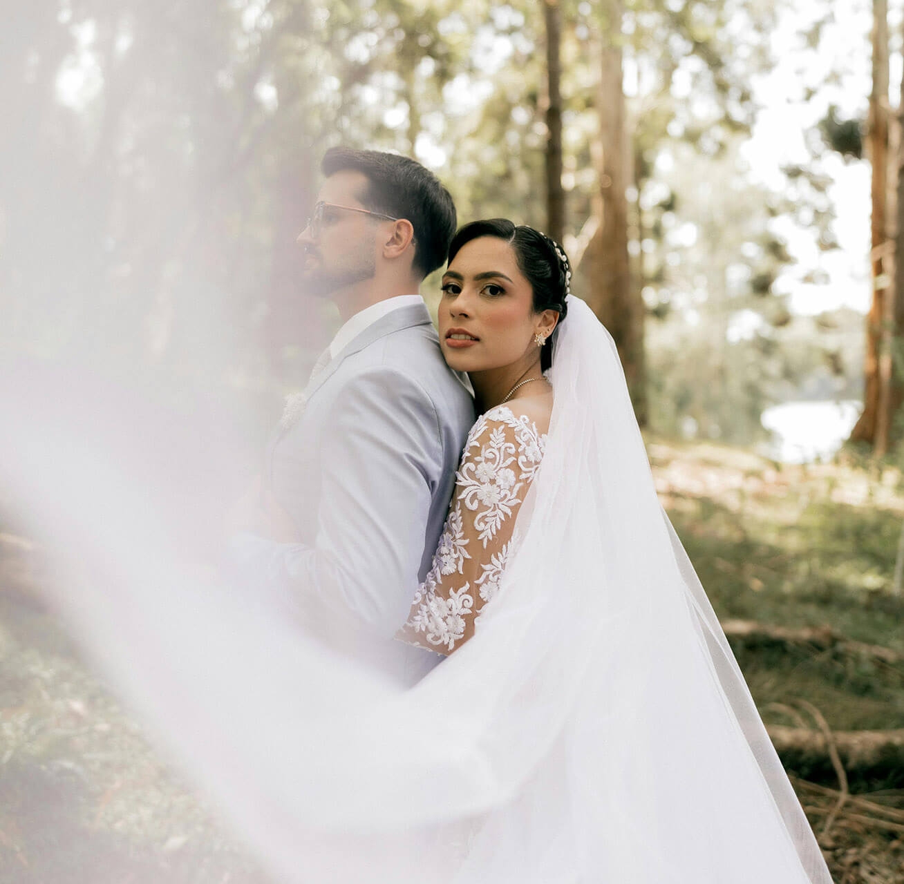 Сouple wearing a white gown and a white suit. Mobile image
