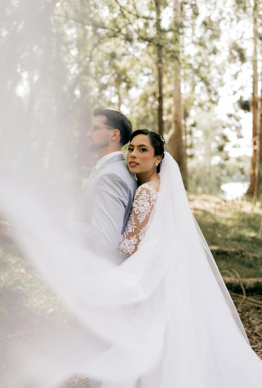 Сouple wearing a white gown and a white suit
