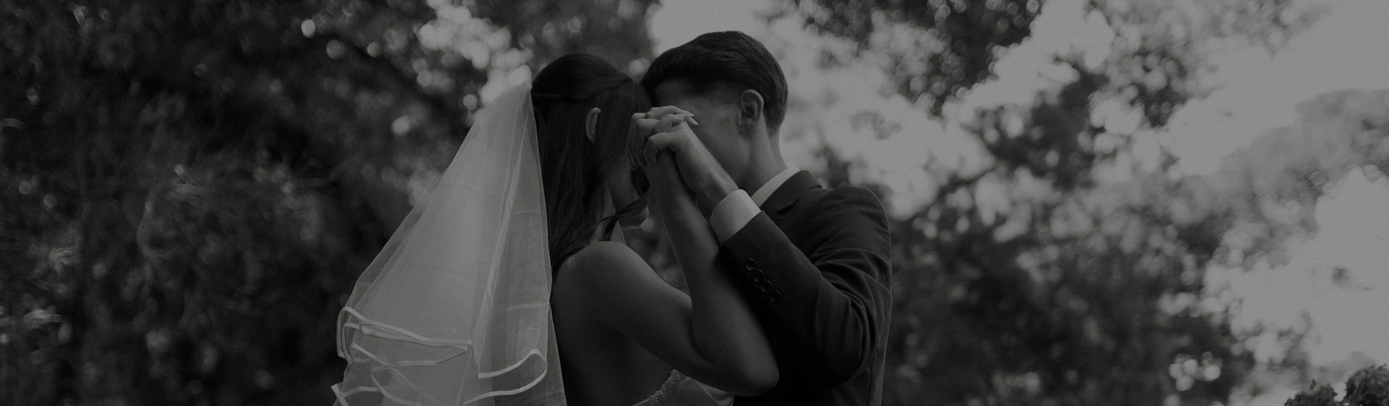 Сouple wearing a white gown and a black suit